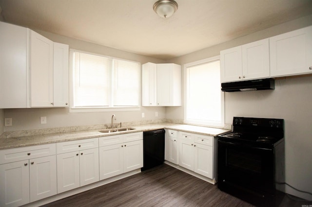 kitchen featuring under cabinet range hood, a sink, white cabinetry, black appliances, and dark wood finished floors