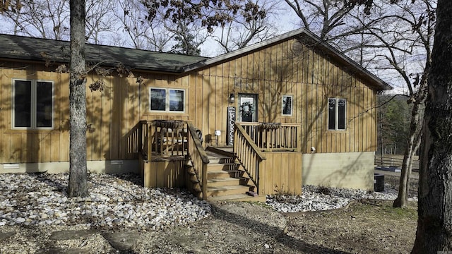 chalet / cabin with a shingled roof, crawl space, and board and batten siding