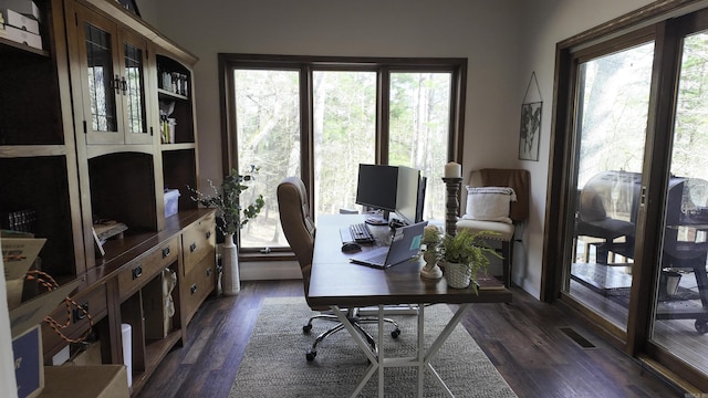 home office featuring dark wood-style flooring and visible vents