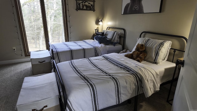 bedroom featuring carpet flooring and baseboards