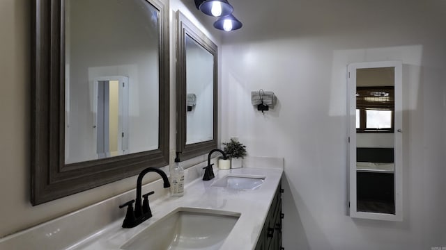 full bathroom with a sink and double vanity