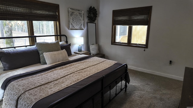 carpeted bedroom featuring baseboards