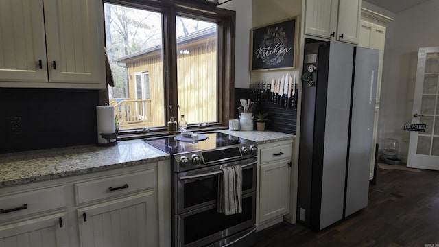 kitchen featuring appliances with stainless steel finishes, dark wood-style flooring, white cabinets, and light stone countertops