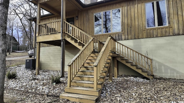 exterior space featuring a chimney, stairway, and central air condition unit