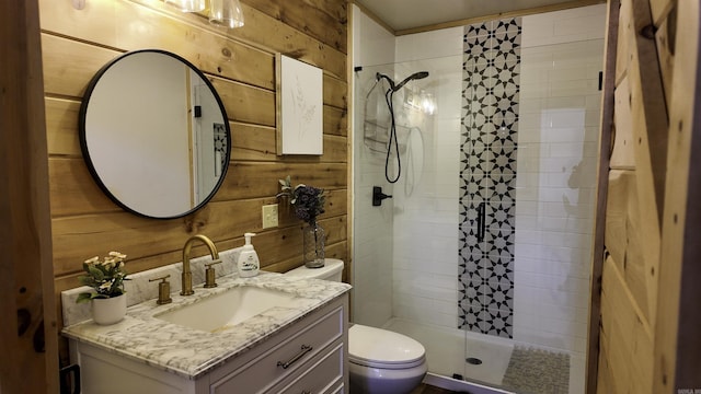 bathroom with toilet, wood walls, a shower stall, and vanity