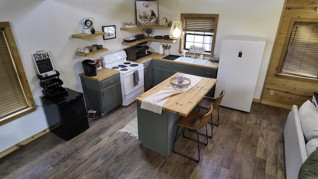 kitchen with white appliances, a kitchen breakfast bar, gray cabinets, open shelves, and a sink