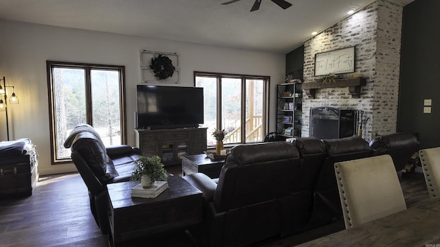 living room featuring ceiling fan, a fireplace, vaulted ceiling, and wood finished floors