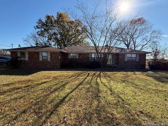 single story home featuring a front yard and brick siding