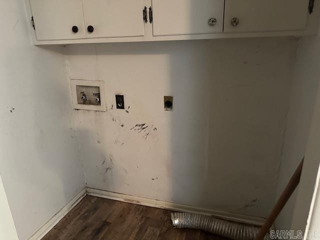 clothes washing area featuring hookup for a washing machine, cabinet space, dark wood-type flooring, hookup for an electric dryer, and baseboards