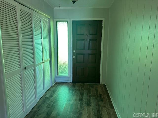 entrance foyer with ornamental molding and wood finished floors