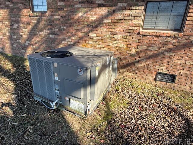 exterior details featuring crawl space, central AC unit, and brick siding