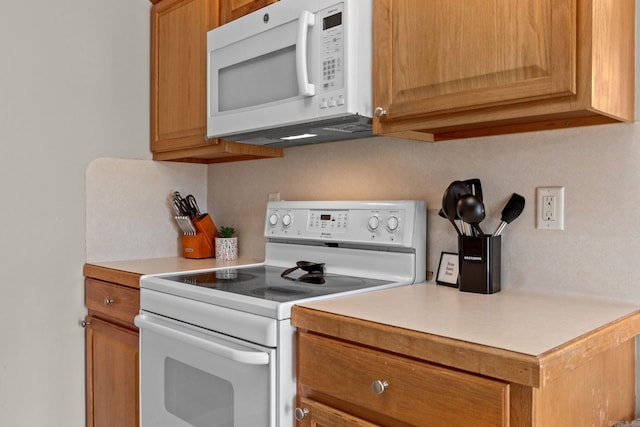 kitchen featuring light countertops and white appliances