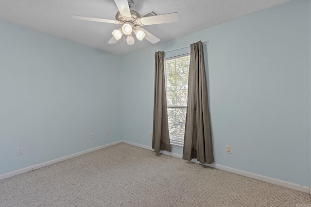 spare room featuring a ceiling fan, light carpet, a textured ceiling, and baseboards