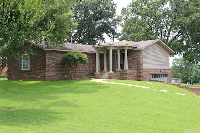 view of front facade featuring brick siding, a front lawn, and a garage