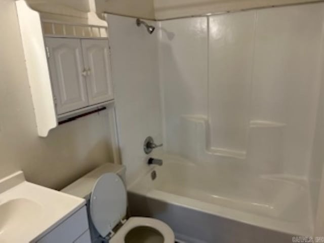 bathroom featuring shower / washtub combination, vanity, and toilet