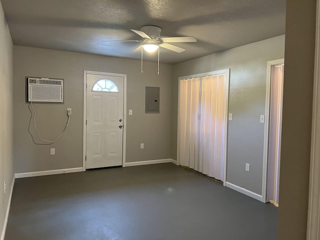 foyer entrance featuring electric panel, baseboards, concrete flooring, and an AC wall unit