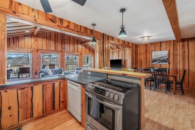 kitchen featuring light wood-style flooring, wooden walls, open floor plan, electric stove, and dishwasher