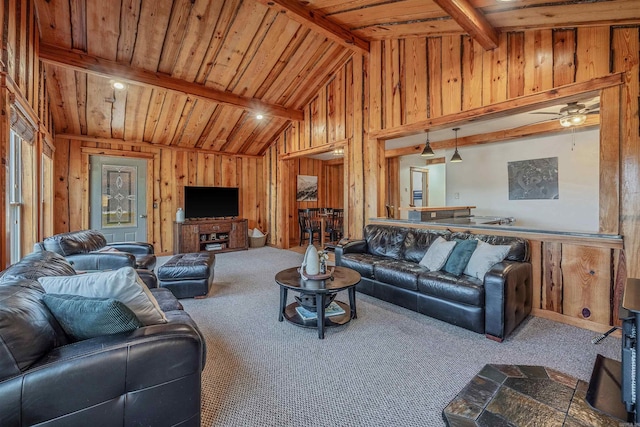 carpeted living area featuring wooden ceiling, vaulted ceiling with beams, wooden walls, and ceiling fan