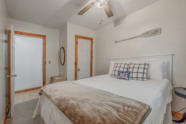 bedroom with ceiling fan, baseboards, and wood finished floors