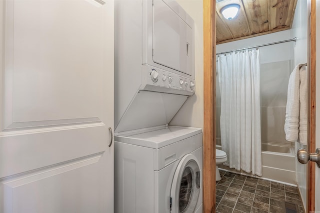 washroom featuring visible vents, laundry area, wooden ceiling, and stacked washer and clothes dryer