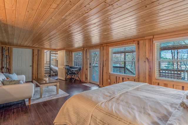 bedroom with wooden ceiling, access to outside, wooden walls, and hardwood / wood-style floors