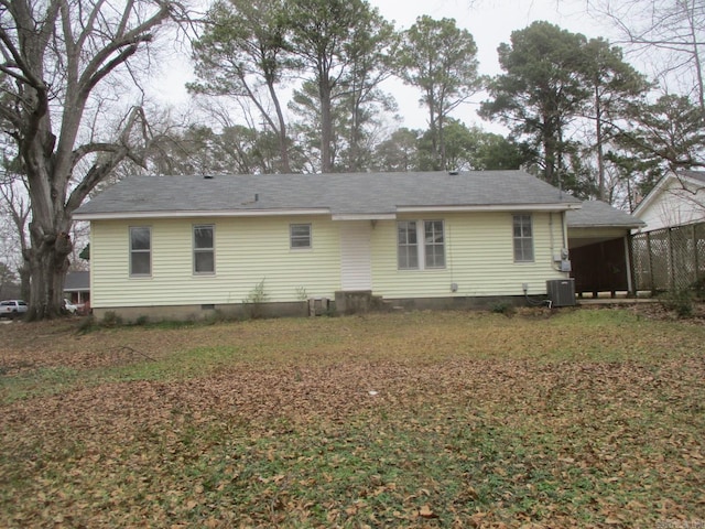 rear view of property featuring an attached carport, crawl space, a lawn, and central AC unit