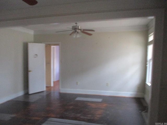 empty room with ceiling fan and baseboards