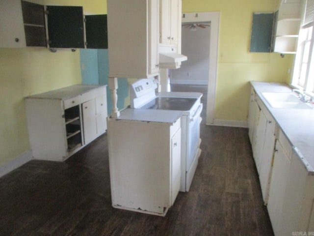 kitchen featuring light countertops, electric range, dark wood-type flooring, white cabinets, and a sink