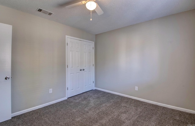 unfurnished bedroom featuring baseboards, a textured ceiling, visible vents, and carpet flooring