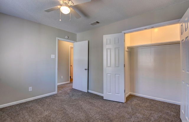 unfurnished bedroom featuring a textured ceiling, carpet floors, and visible vents