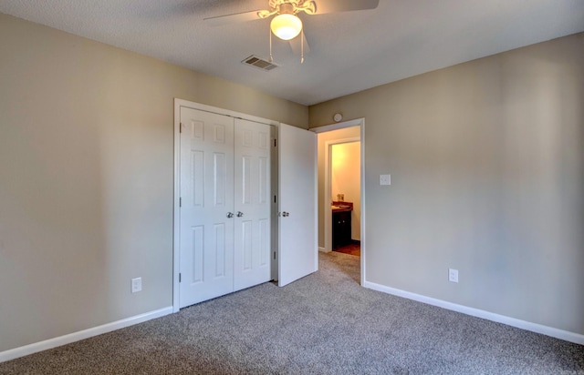 unfurnished bedroom with carpet, visible vents, and baseboards