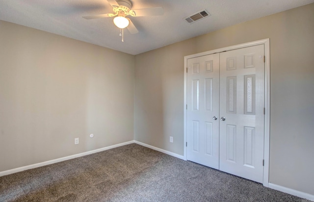 unfurnished bedroom featuring carpet, a closet, visible vents, and baseboards