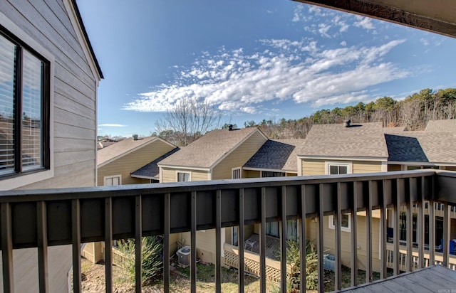 balcony with central AC unit and a residential view