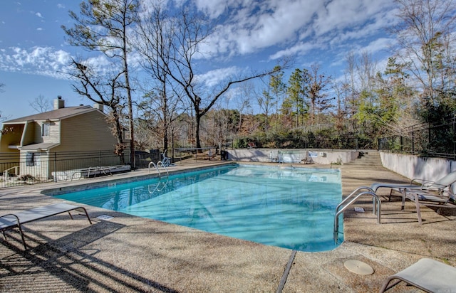 community pool featuring fence