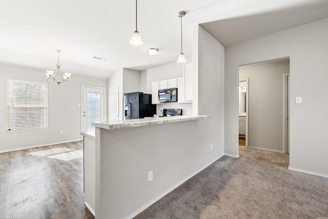 kitchen featuring a peninsula, black appliances, pendant lighting, and white cabinets