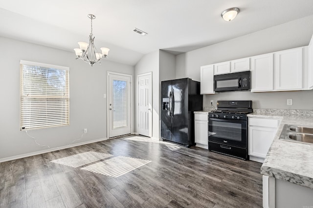 kitchen with dark wood-type flooring, white cabinets, light countertops, black appliances, and pendant lighting