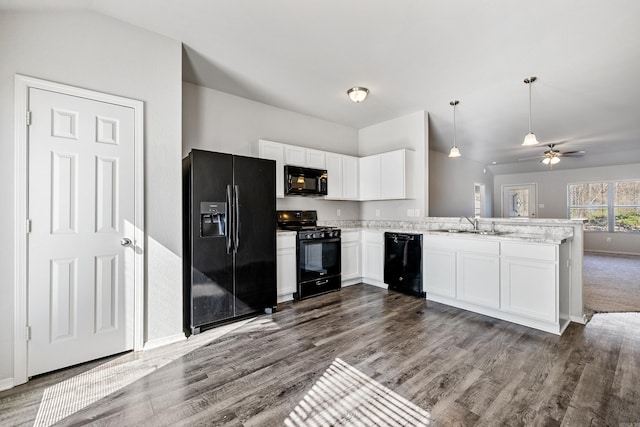 kitchen with hanging light fixtures, dark wood-type flooring, open floor plan, white cabinetry, and black appliances