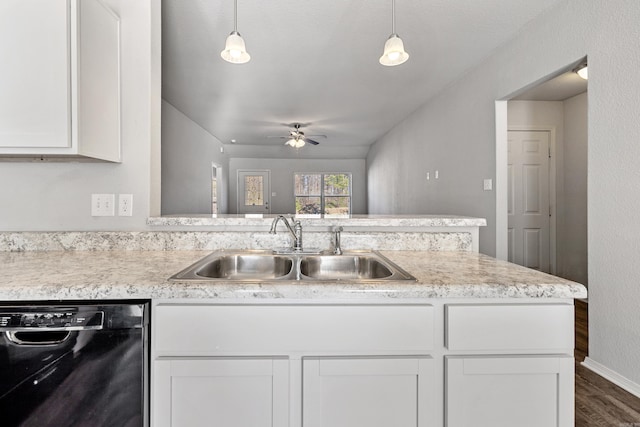 kitchen with a sink, white cabinets, light countertops, dishwasher, and pendant lighting