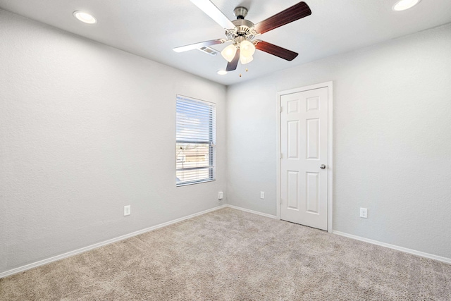 empty room featuring baseboards, visible vents, a ceiling fan, carpet, and recessed lighting