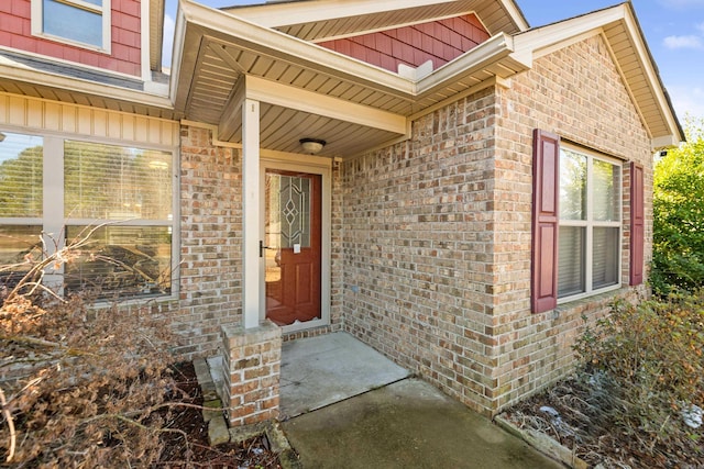 doorway to property with brick siding and board and batten siding