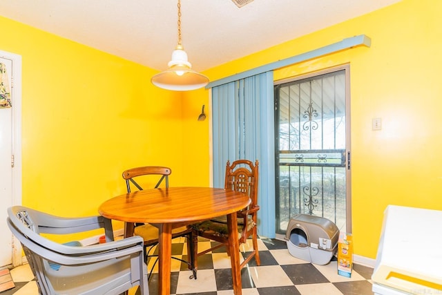 dining space with baseboards and tile patterned floors