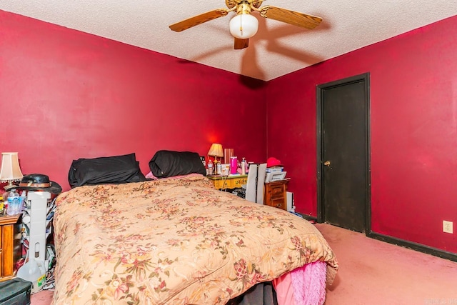 bedroom featuring carpet floors, a ceiling fan, and a textured ceiling