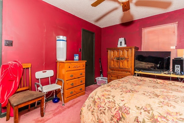 bedroom featuring a ceiling fan, light colored carpet, a fireplace, and a textured ceiling