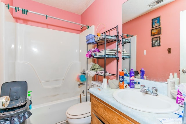 full bath featuring shower / bath combination, visible vents, toilet, a textured ceiling, and vanity