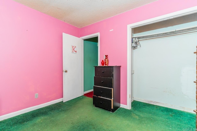 carpeted bedroom featuring a textured ceiling and baseboards