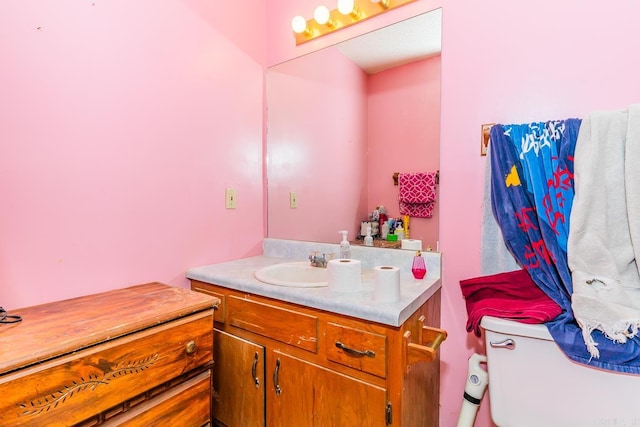 bathroom featuring toilet and vanity