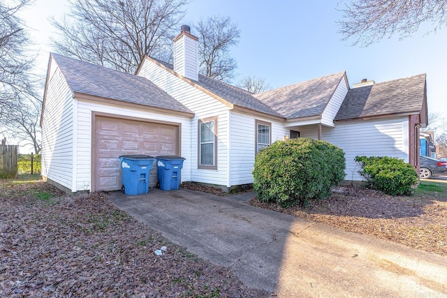 view of property exterior with a shingled roof, concrete driveway, a chimney, and an attached garage