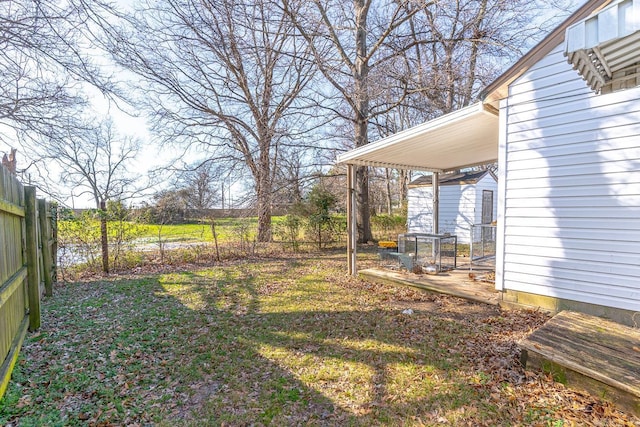 view of yard with a carport and a fenced backyard