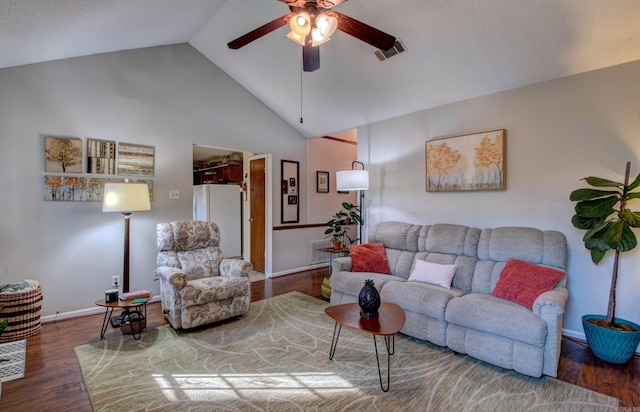 living area featuring high vaulted ceiling, wood finished floors, visible vents, baseboards, and a ceiling fan