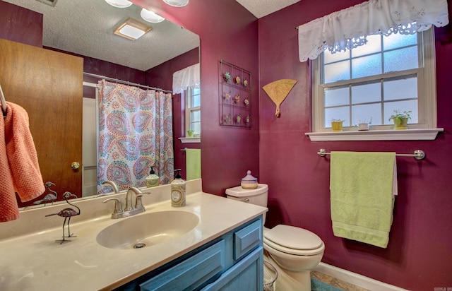 bathroom with toilet, baseboards, a textured ceiling, and vanity